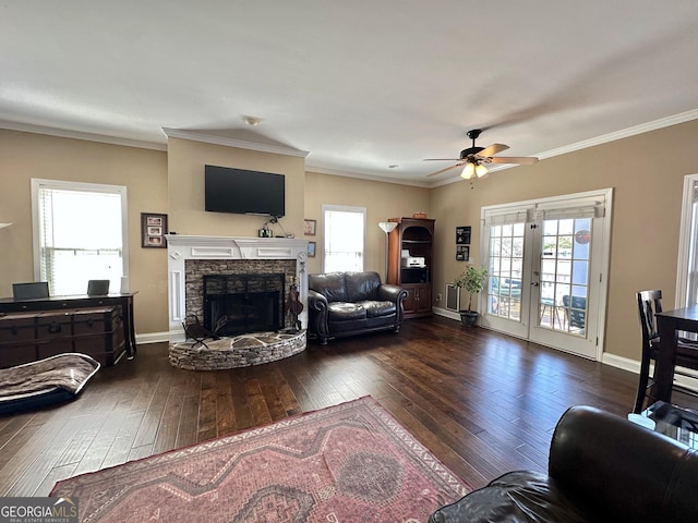 living area with plenty of natural light, a fireplace, and hardwood / wood-style floors