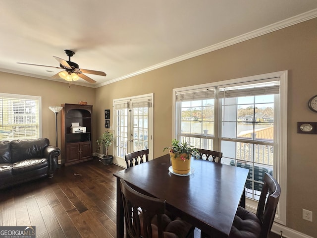 dining room featuring a healthy amount of sunlight, dark wood finished floors, crown molding, and french doors