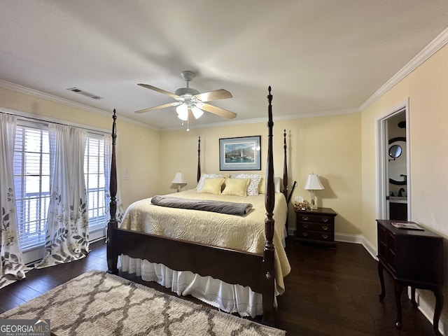 bedroom featuring ornamental molding, wood finished floors, visible vents, and baseboards