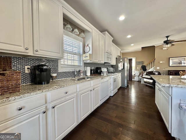 375 Templeton Cir, Mansfield, GA 30055 - kitchen featuring a sink, white appliances, white cabinetry, tasteful backsplash, and ceiling fan