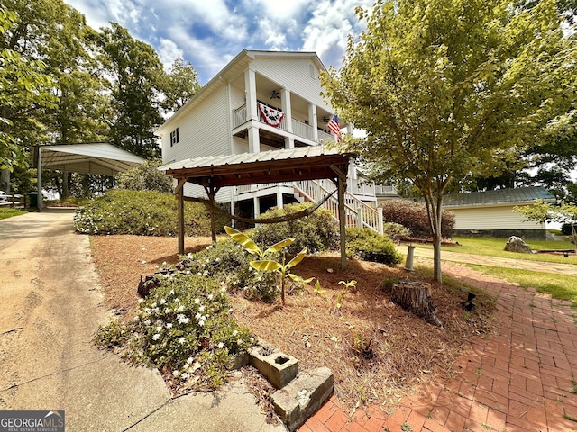 375 Templeton Cir, Mansfield, GA 30055 - view of front facade featuring ceiling fan, a balcony, and stairs