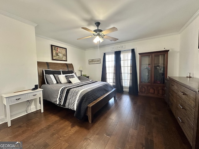 bedroom with ornamental molding, dark wood-type flooring, and a ceiling fan