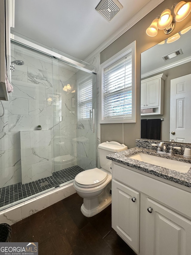 full bathroom with toilet, a marble finish shower, visible vents, and crown molding