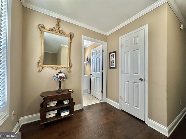 entrance foyer featuring wood-type flooring, crown molding, and baseboards