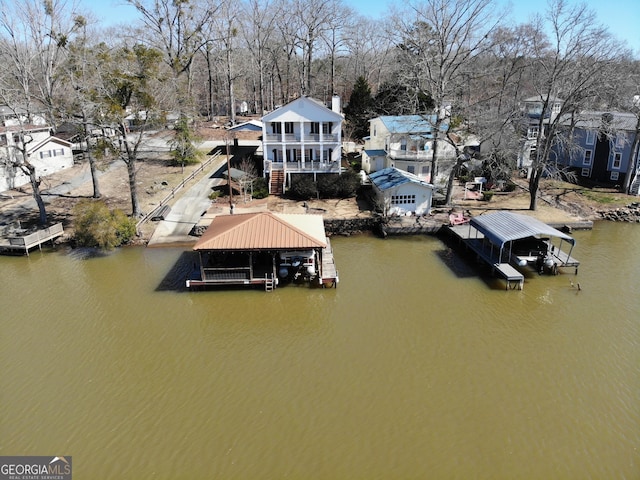 view of dock featuring a water view, boat lift, and stairs