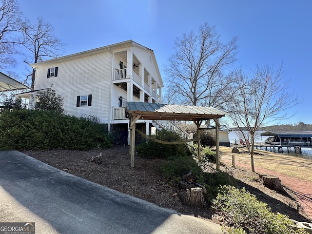 exterior space featuring a balcony and a ceiling fan