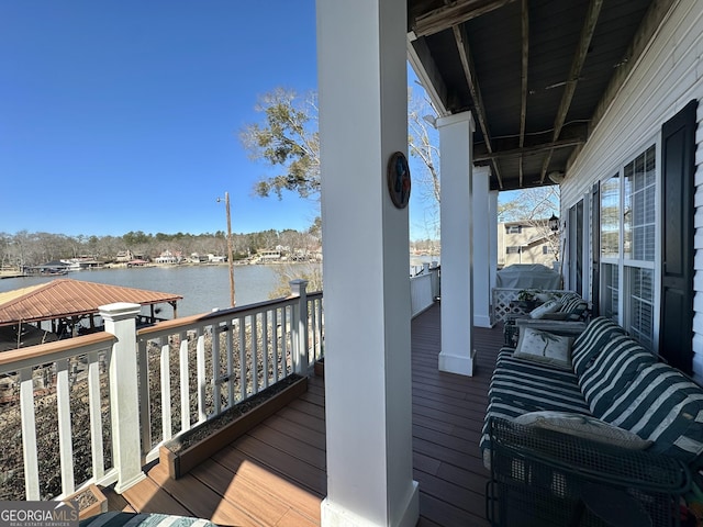 wooden terrace featuring a water view