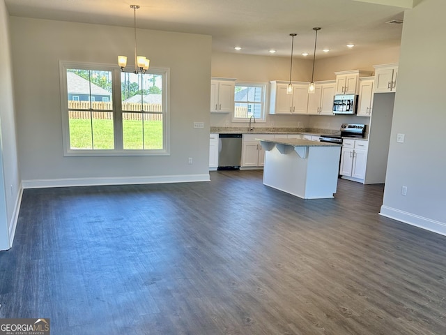 524 Doyle Ln Unit 16, Statesboro, GA 30458 - kitchen with appliances with stainless steel finishes, baseboards, dark wood-style flooring, white cabinetry, and a center island