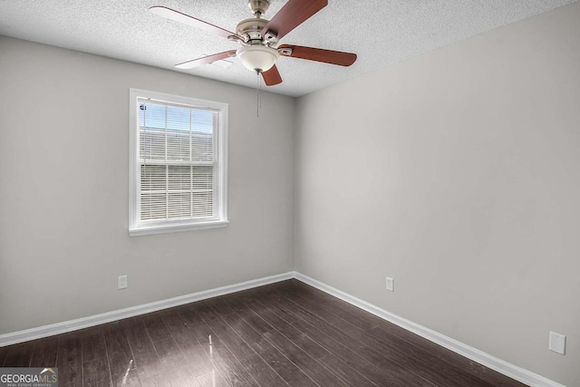 spare room with ceiling fan, a textured ceiling, baseboards, and dark wood-type flooring