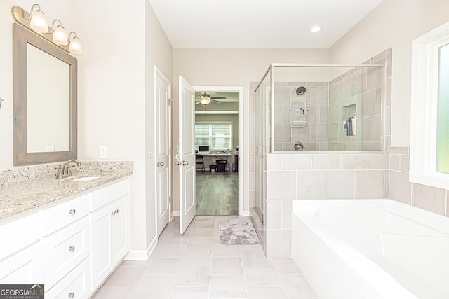 ensuite bathroom with a garden tub, a stall shower, ceiling fan, vanity, and tile patterned floors