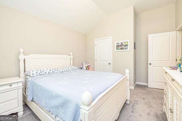 bedroom with lofted ceiling, light carpet, and baseboards