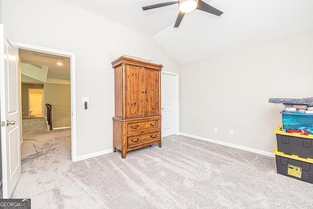 carpeted bedroom featuring baseboards, vaulted ceiling, and a ceiling fan