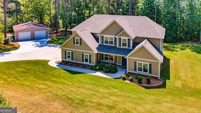 craftsman-style house with a front yard, a detached garage, a view of trees, and an outdoor structure