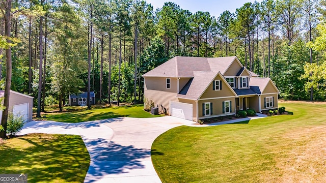 craftsman-style house featuring an attached garage, a front yard, and central air condition unit