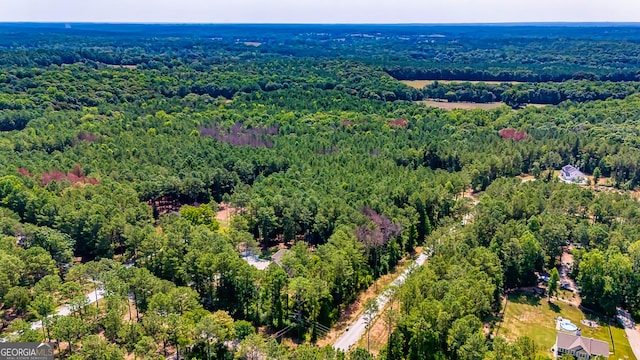 birds eye view of property with a view of trees