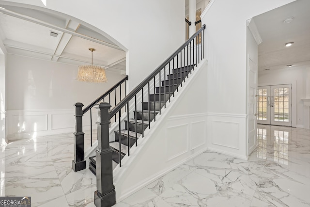 stairway featuring marble finish floor, french doors, recessed lighting, visible vents, and a decorative wall