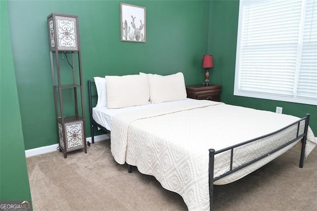 carpeted bedroom with baseboards