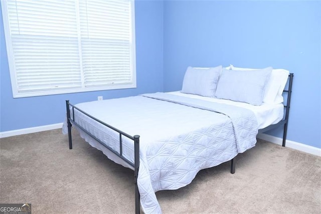 bedroom with carpet and baseboards