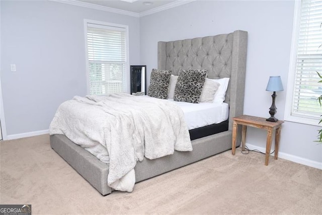 carpeted bedroom featuring crown molding and baseboards