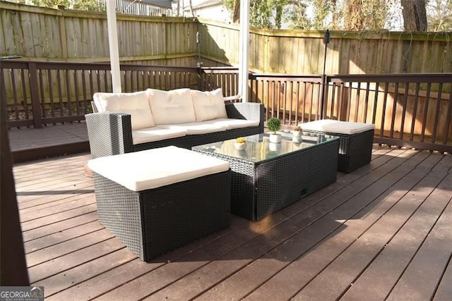 deck with outdoor lounge area and fence