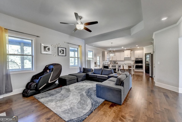 living room featuring dark wood-style floors, recessed lighting, baseboards, and ornamental molding