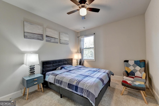 bedroom featuring light carpet, ceiling fan, visible vents, and baseboards