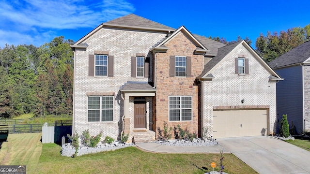 traditional-style house featuring a front yard, concrete driveway, brick siding, and fence