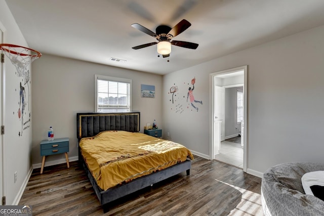 bedroom featuring a ceiling fan, dark wood finished floors, visible vents, and baseboards