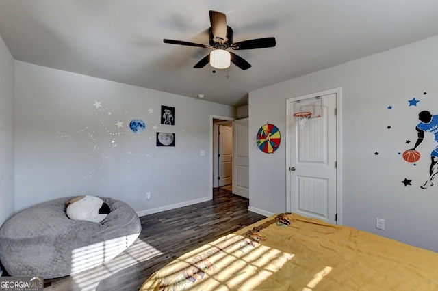 unfurnished bedroom featuring a ceiling fan, baseboards, and wood finished floors