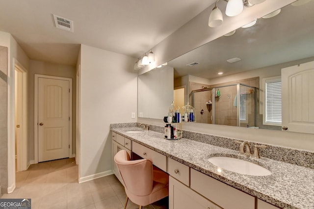 full bathroom featuring a stall shower, a sink, and visible vents