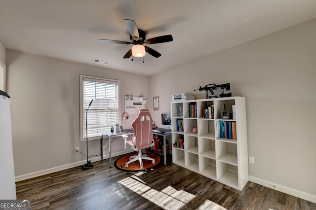 office area with wood finished floors, visible vents, and baseboards