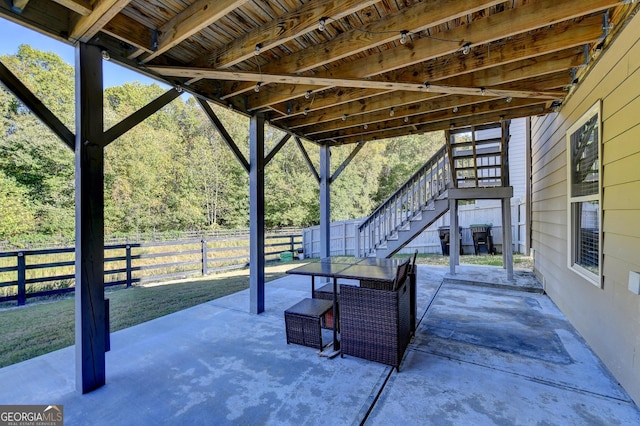 view of patio / terrace with stairway and fence