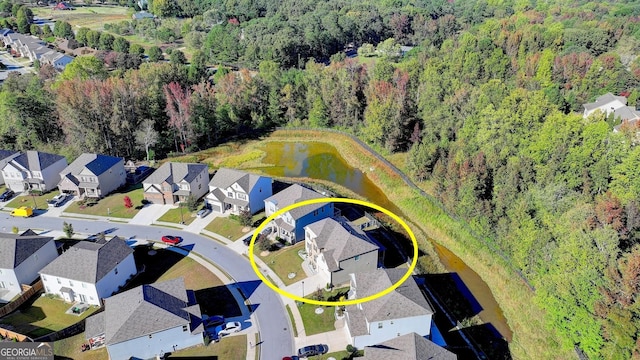 birds eye view of property featuring a residential view and a view of trees