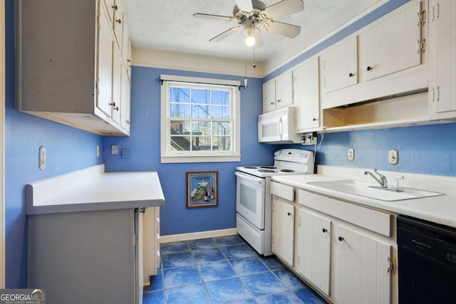 kitchen featuring white appliances, a textured ceiling, light countertops, and a sink