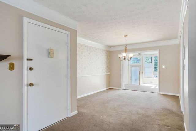 interior space with baseboards, carpet, crown molding, a textured ceiling, and a chandelier