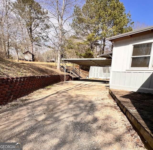 view of yard with a carport and driveway