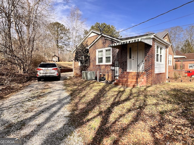 view of front of property featuring driveway and brick siding