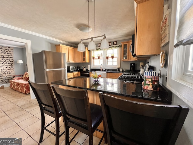 kitchen with a peninsula, a textured ceiling, glass insert cabinets, and crown molding