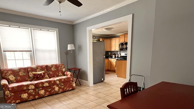 living area with light tile patterned floors, baseboards, a ceiling fan, and crown molding