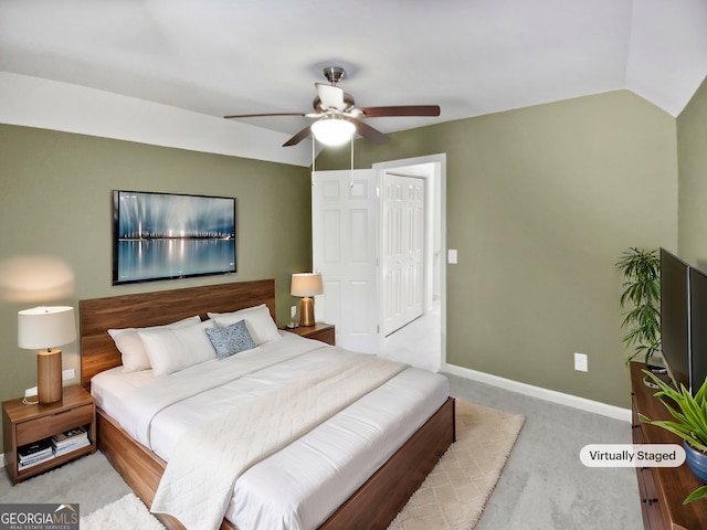 carpeted bedroom featuring a ceiling fan, lofted ceiling, and baseboards