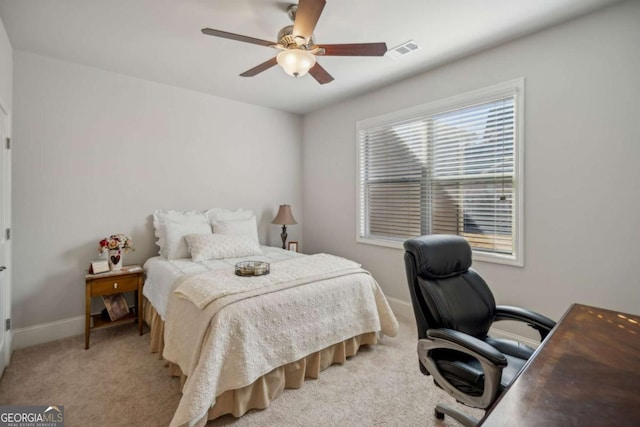 bedroom featuring light carpet, a ceiling fan, visible vents, and baseboards