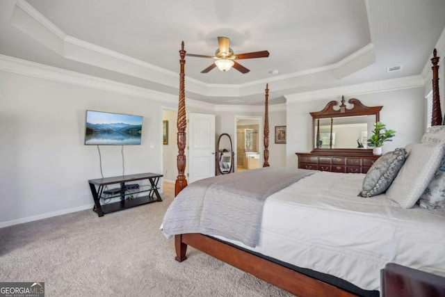 bedroom with carpet floors, a tray ceiling, and visible vents