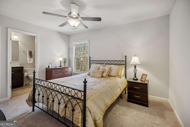 bedroom featuring baseboards, visible vents, a ceiling fan, connected bathroom, and light colored carpet