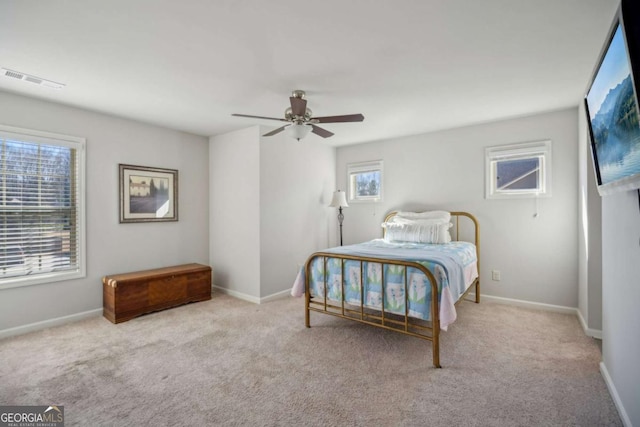 carpeted bedroom featuring baseboards, visible vents, and ceiling fan