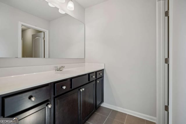 bathroom with tile patterned flooring, baseboards, and vanity