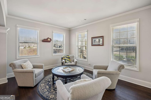 living area with plenty of natural light, baseboards, and wood finished floors