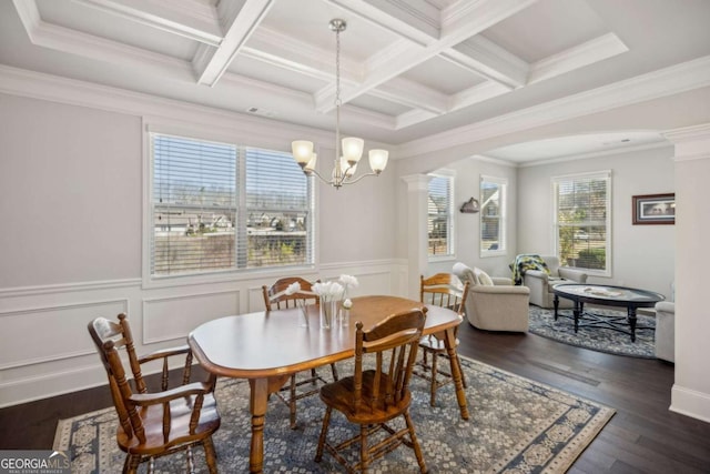 dining room with dark wood-style floors, beam ceiling, coffered ceiling, and ornate columns