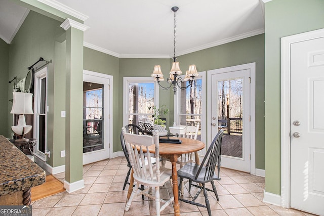 dining space with light tile patterned floors, an inviting chandelier, baseboards, and crown molding