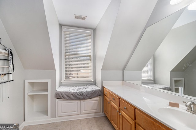 bathroom featuring vaulted ceiling, tile patterned flooring, vanity, and visible vents