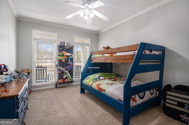 carpeted bedroom featuring ornamental molding and a ceiling fan